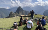 G Adventures guide Edwar Pacheco talks about the history of Machu Picchu from one of the site's overlook areas. The daily visitor cap for Machu Picchu is expected to rise from 4,044 to 4,500 this year.