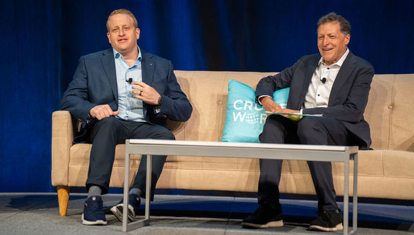 Royal Caribbean Group CEO Jason Liberty (left) speaking on the CruiseWorld stage with Travel Weekly editor in chief Arnie Weissmann.
