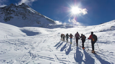 Group of touring skiers, the Alps, Valle d'Aosta, Italy. There are multiple reports of 20 inches across the Alps in various regions and as of the turn of the new year, some 60 ski resorts are already open in France, Italy, Austria and Germany.