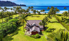 The Red House is beachfront at Hanalei Bay and includes a four-bedroom main house and a one-bedroom guesthouse.