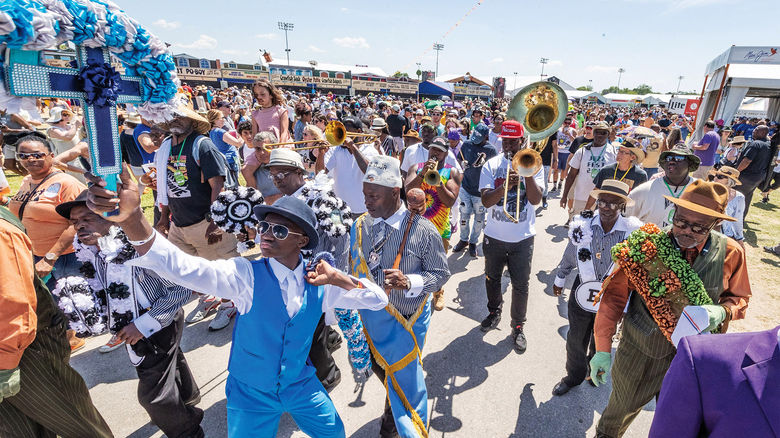 The New Generation Brass Band leads a second line at the New Orleans Jazz & Heritage Festival.